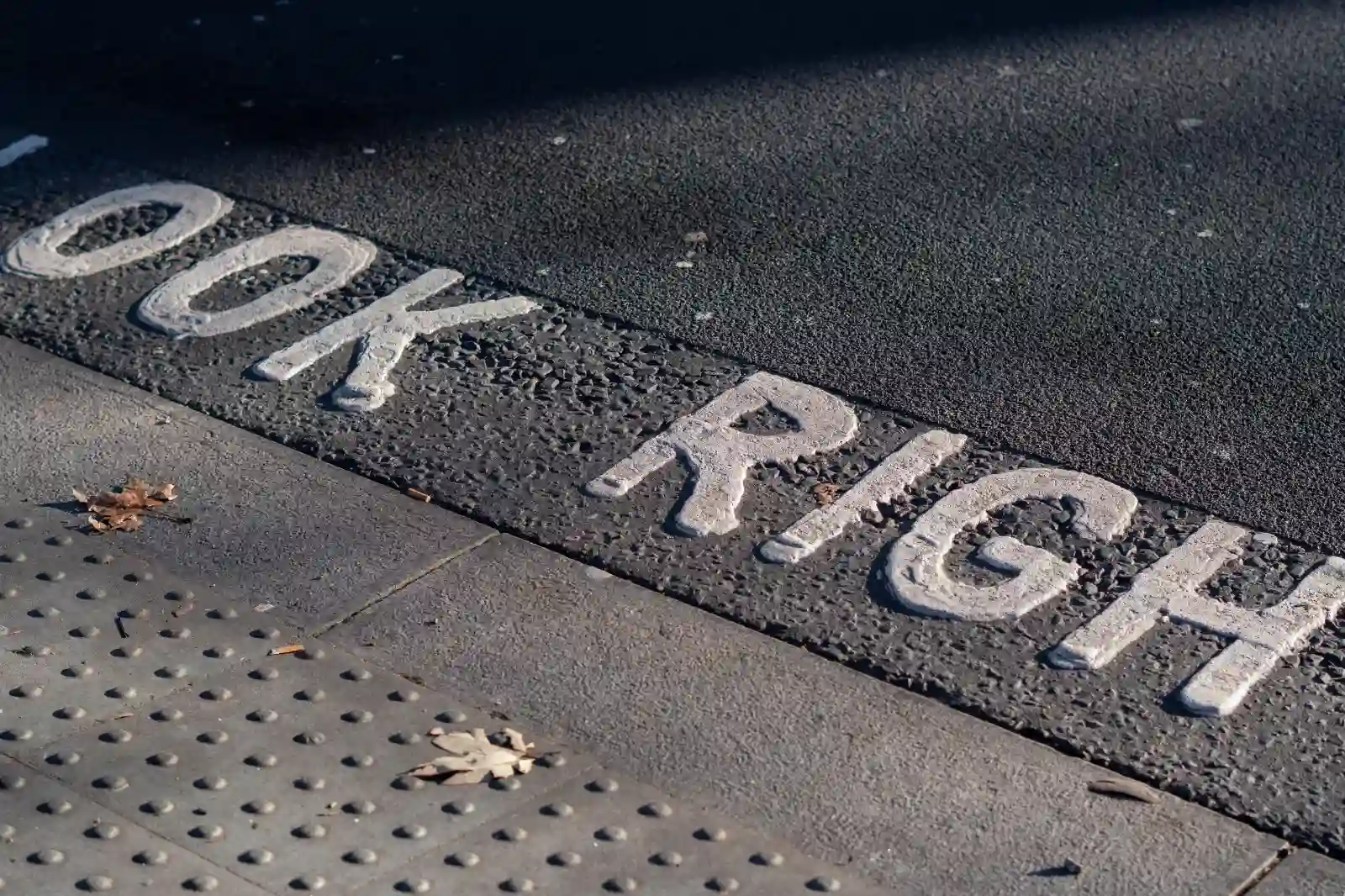 detail of a London street crossing showing the words look right